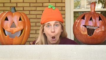 Dentist making funny faces with pumpkins
