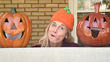 Doctor making funny face with pumpkins