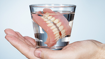 Full dentures in a glass of water