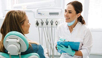 Dentist taking notes during patient consultation