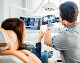 Dentist and patient looking at X-ray