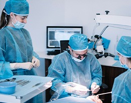 Oral surgery team carefully working on patient